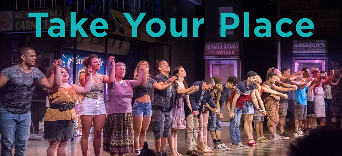 The cast of In the Heights on stage, below the words "Take Your Place" in large blue letters.