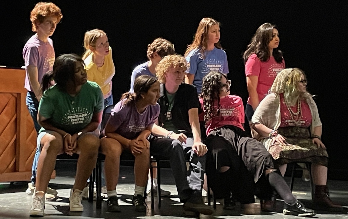 Students on stage in a musical number